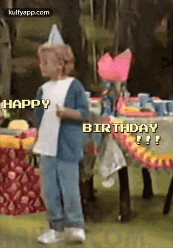 A Little Boy Wearing A Party Hat Is Standing In Front Of A Table With The Words Happy Birthday Written On It . GIF