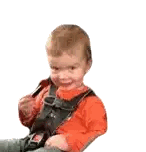 a little boy wearing a seat belt is sitting on a chair .