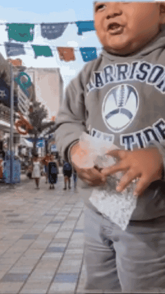 A Little Boy Wearing A Sweatshirt That Says " Arrison " On It GIF
