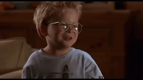 A Little Boy Wearing Glasses Is Sitting On A Couch And Saying `` The Human Head Weighs Eight Pounds '' . GIF