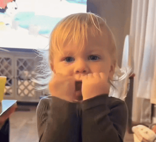 A Little Boy With Blonde Hair Is Making A Surprised Face GIF