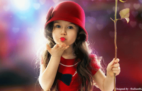 A Little Girl Blowing A Kiss While Holding A Rose In Her Hand GIF
