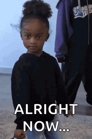 A Little Girl In A Black Sweater Is Holding A Bottle Of Water And Says Alright Now . GIF
