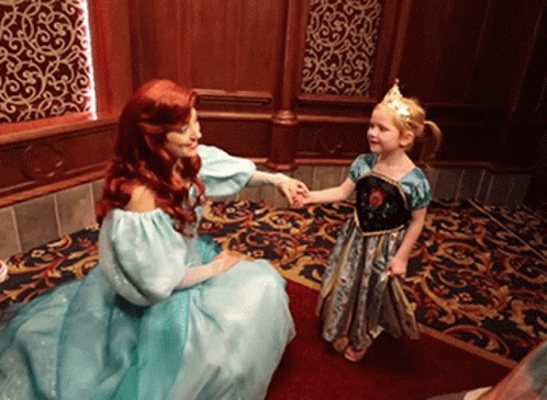 A Little Girl In A Blue Dress Is Holding Hands With A Princess GIF