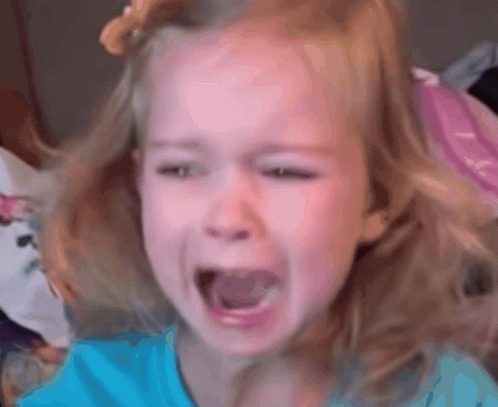 A Little Girl In A Blue Shirt Is Crying GIF