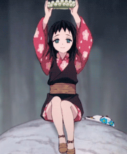 A Little Girl In A Kimono Is Sitting On A Rock GIF