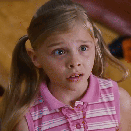 A Little Girl In A Pink And White Striped Shirt Looks Surprised GIF