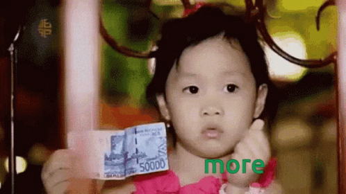 A Little Girl In A Pink Dress Is Holding Up A 5000 Rupiah Bill GIF
