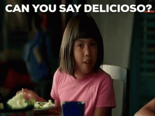 A Little Girl In A Pink Shirt Is Sitting At A Table Eating A Salad . GIF