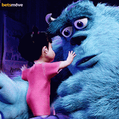 A Little Girl In A Pink Shirt Is Standing Next To A Monster From The Movie Monsters Inc. GIF