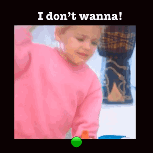 A Little Girl In A Pink Sweater Is Playing With A Green Ball And The Words I Don 'T Wanna Are Above Her . GIF