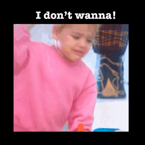 A Little Girl In A Pink Sweater With The Words I Don 'T Wanna Written Below Her GIF