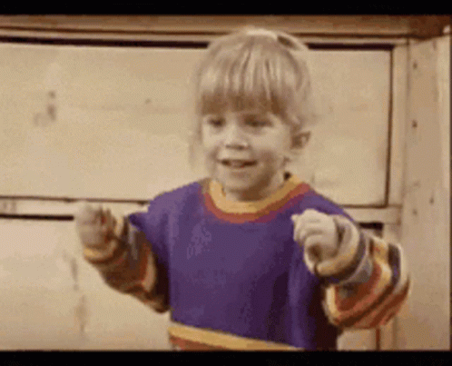 A Little Girl In A Purple Shirt Is Pointing GIF
