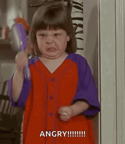 A Little Girl In A Red And Purple Dress Is Brushing Her Hair . GIF