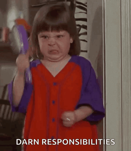 A Little Girl In A Red And Purple Dress Is Holding A Brush And Making A Face . GIF