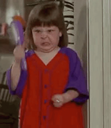 Girl In Red And Purple Shirt Making Angry Face GIF