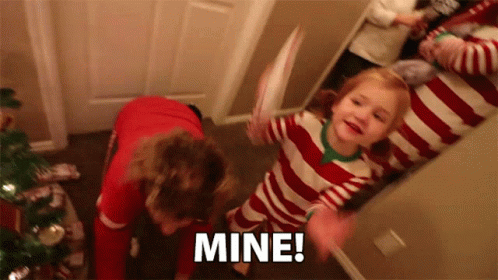 A Little Girl In A Red And White Striped Pajamas Is Holding A Piece Of Paper And Says Mine GIF