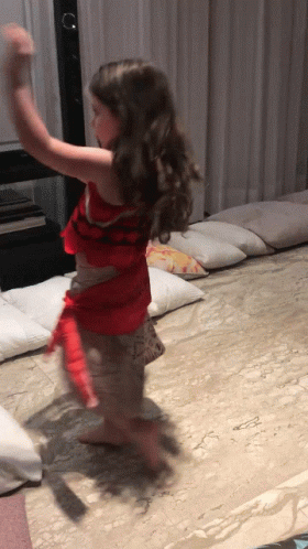 A Little Girl In A Red Dress Is Dancing On A Carpet GIF