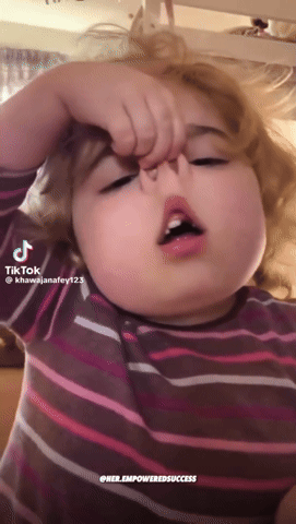 A Little Girl In A Striped Shirt Is Making A Funny Face With A Tiktok Hashtag GIF