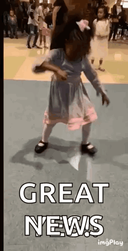 A Little Girl Is Dancing In A Room With The Words `` Great News '' Written Above Her . GIF