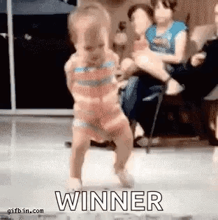A Little Girl Is Dancing In Front Of A Group Of People And The Word Winner Is Visible . GIF