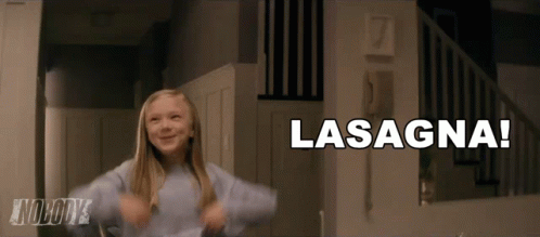 A Little Girl Is Dancing In Front Of A Sign That Says Lasagna On It GIF