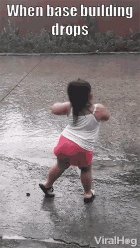 A Little Girl Is Dancing In The Rain With The Caption When Base Building Drops Viralhog GIF