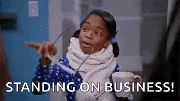 A Little Girl Is Holding A Cup Of Coffee And Pointing At Something While Standing On A Business . GIF