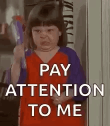 A Little Girl Is Holding A Toy Gun And Making A Funny Face While Saying `` Pay Attention To Me '' . GIF