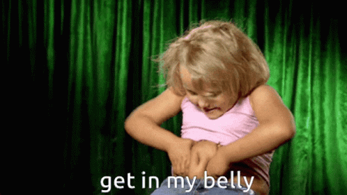 A Little Girl Is Looking At Her Belly And Says Get In My Belly GIF