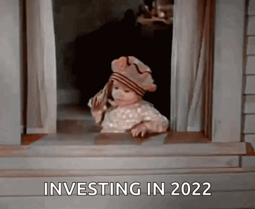 A Little Girl Is Looking Out Of A Window With The Words Investing In 2022 Written On The Bottom GIF