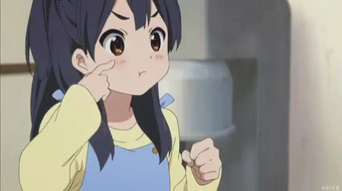 A Little Girl Is Making A Funny Face And Pointing At Her Nose . GIF