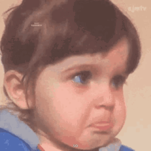 A Little Girl Is Making A Sad Face With Her Eyes Closed . GIF