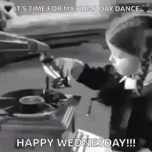 a little girl is playing music on a record player .