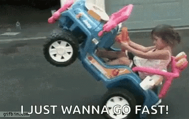A Little Girl Is Riding A Toy Car With The Words Just Wanna Go Fast Written Below Her . GIF