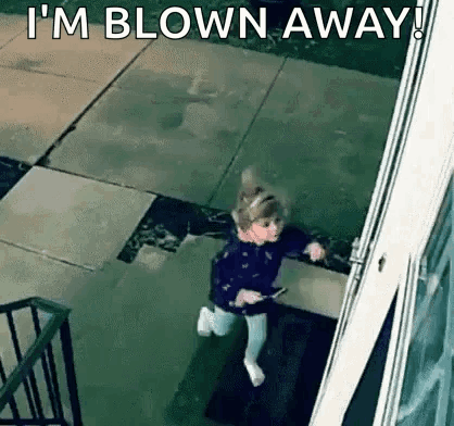 A Little Girl Is Running Out Of A Doorway With The Words `` I 'M Blown Away '' . GIF