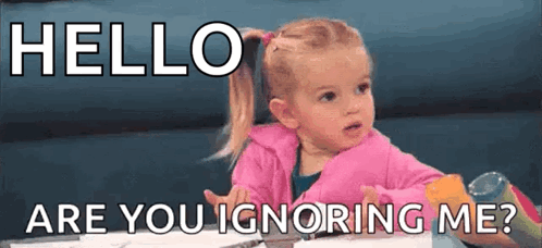 A Little Girl Is Sitting At A Table With The Words `` Hello Are You Ignoring Me ? '' Written On It . GIF