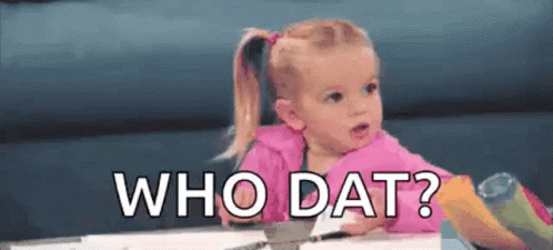 A Little Girl Is Sitting At A Table With The Words `` Who Dat '' Written Above Her . GIF