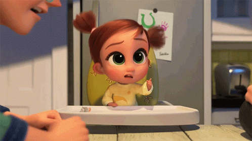 A Little Girl Is Sitting In A High Chair And Looking At Something GIF