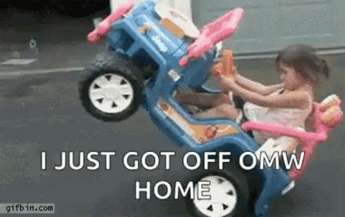 A Little Girl Is Sitting In A Toy Car With A Monkey . GIF