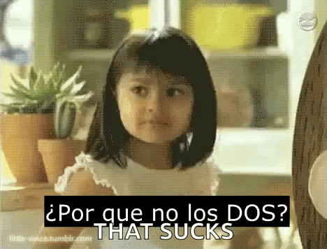 A Little Girl Is Sitting In Front Of Potted Plants And A Sign That Says Por Que No Los Dos That Sucks . GIF