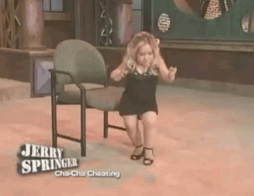 A Little Girl Is Sitting On A Chair On Jerry Springer 'S Show . GIF
