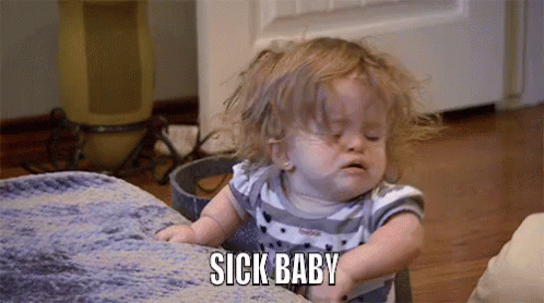 A Little Girl Is Sitting On A Couch And Making A Funny Face . GIF