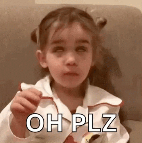 A Little Girl Is Sitting On A Couch Eating A Candy Bar And Making A Face . GIF
