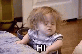 A Little Girl Is Sitting On A Couch Making A Funny Face . GIF