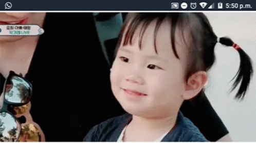 Smiling Girl Looking At Cell Phone GIF