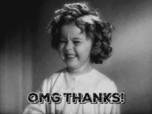 A Little Girl Is Smiling In A Black And White Photo With The Words `` Omg Thanks '' . GIF