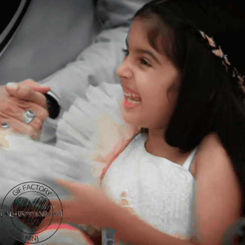 A Little Girl Is Smiling In A Photo That Was Taken By The Gif Factory GIF