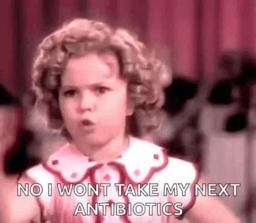 A Little Girl Is Standing In Front Of A Red Curtain And Says `` No I Won T Take My Next Antibiotics '' . GIF