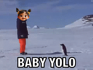 A Little Girl Is Standing In The Snow Next To A Penguin And The Words Baby Yolo GIF